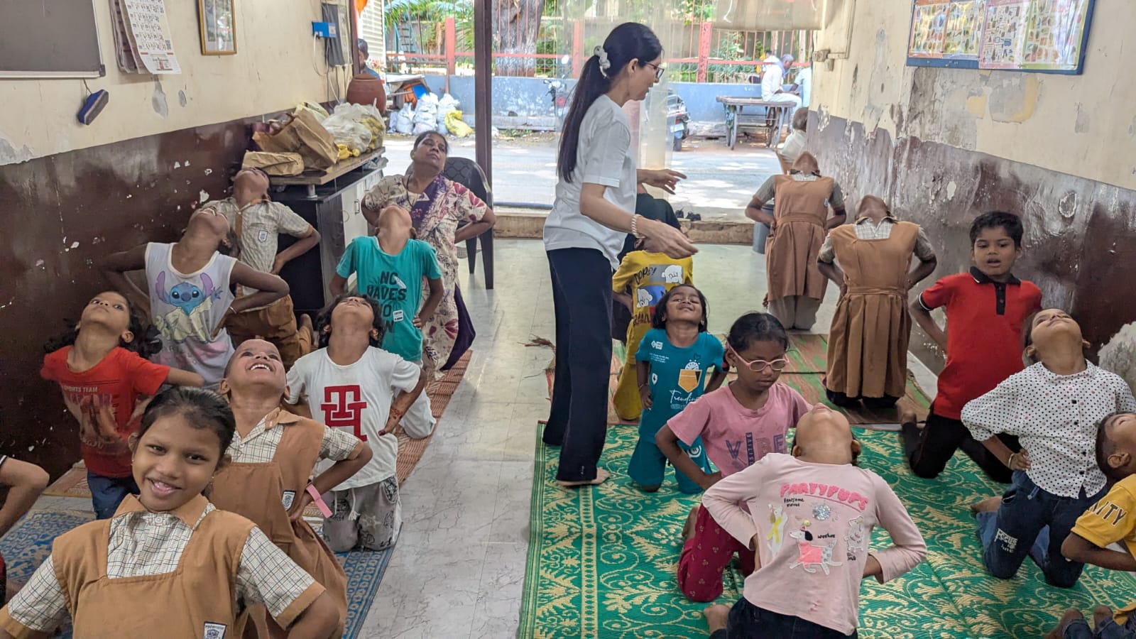 Rachna teaching yoga to children at a community class